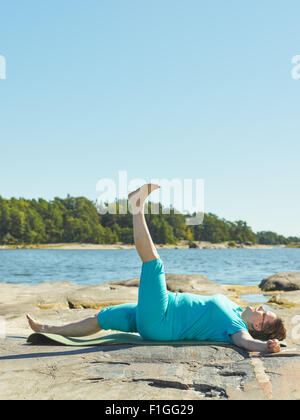 Real-life fitness training, mature woman training outdoor - vertical format image Stock Photo