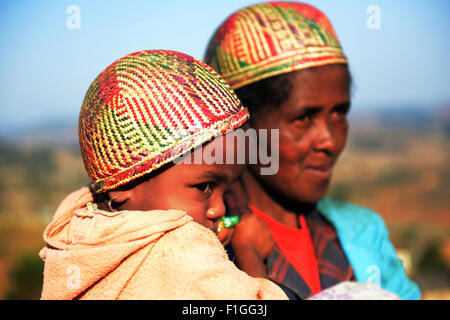 A betsileo woman with her child wearing a traditional betsileo hat. Stock Photo