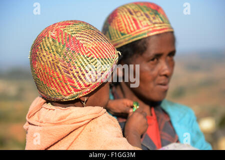 A betsileo woman with her child wearing a traditional betsileo hat. Stock Photo