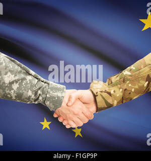 Soldiers handshake and US state flag - Alaska Stock Photo