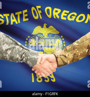 Soldiers handshake and US state flag - Oregon Stock Photo