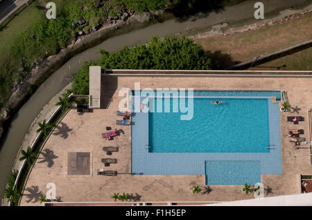 Building, home, house, skyscraper with swimming pool, people relaxing, swimming, having fun, sunbathing in Panama City Stock Photo