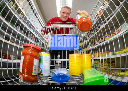 man shopping using trolley in supermarket Stock Photo