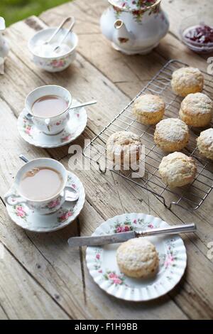 Table with fresh scones and afternoon tea Stock Photo