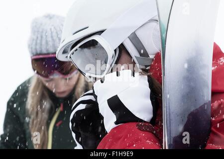 Woman wearing ski goggles and gloves, close up Stock Photo