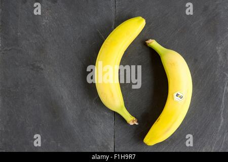 Still life of two bananas - one with bio  label Stock Photo