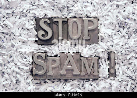 stop spam exclamation made from metallic letterpress type inside of shredded paper heap Stock Photo