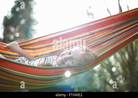 Portrait of young girl on garden hammock