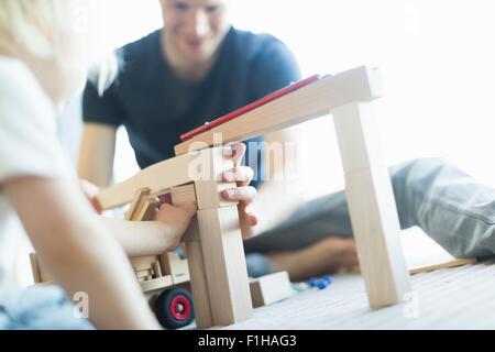 Boy carrying basket of wooden blocks Stock Photo