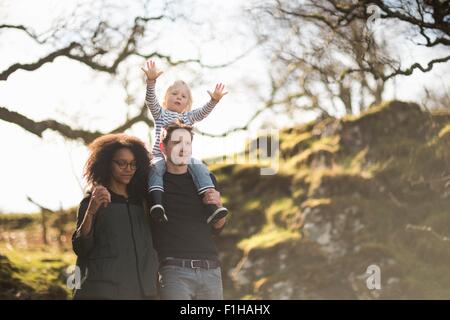 Family on walk, father carrying son on shoulders Stock Photo