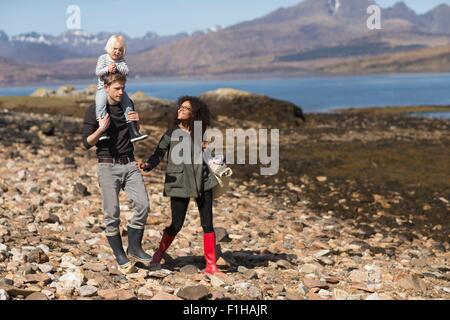 Family on walk, man carrying son on shoulders, Loch Eishort, Isle of Skye, Hebrides, Scotland Stock Photo