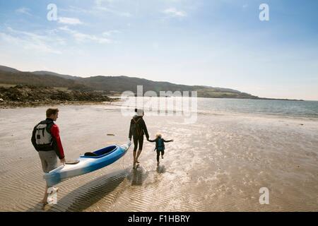 Family with canoe on beach, Loch Eishort, Isle of Skye, Hebrides, Scotland