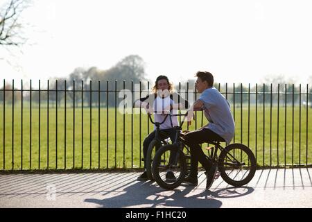 Two young men on bmx bikes at skatepark Stock Photo