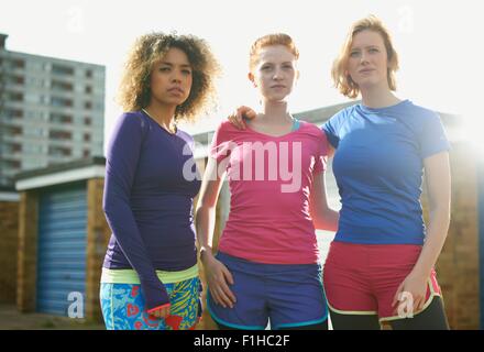 Portrait of three women standing together wearing sports clothing Stock Photo