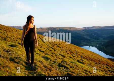 Young woman strolling, Talybont Reservoir in Glyn Collwn valley, Brecon Beacons, Powys, Wales Stock Photo