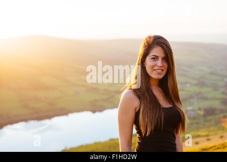 Portrait of young woman, Talybont Reservoir in Glyn Collwn valley, Brecon Beacons, Powys, Wales Stock Photo