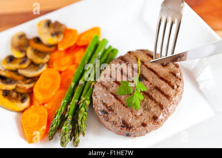 Delicious truffled beef burger with vegetables in a plate Stock Photo
