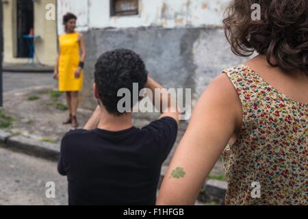 Behind the scenes of an urban fashion shoot with female model and male photographer Stock Photo