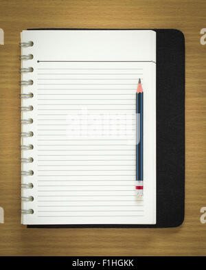 blank spiral notepad and pencil on wood background Stock Photo