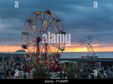 View over Banksy's Dismaland, a Bemusement Park on the seafront in Weston-super-Mare at sunset. Stock Photo
