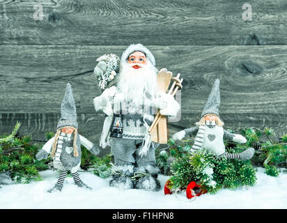 Santa Claus and happy kids in snow. Christmas decoration. Vintage style toned picture Stock Photo