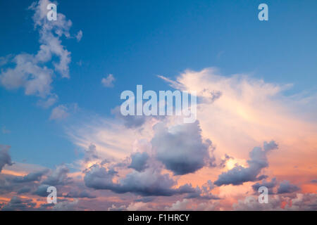 Dramatic colorful cloudscape, summer evening sky background texture with different types of clouds: cirrus, altocumulus, nimbost Stock Photo