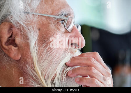 Portrait of a Senior Indian Sikh Man Relaxing at Home without Turban Stock Photo
