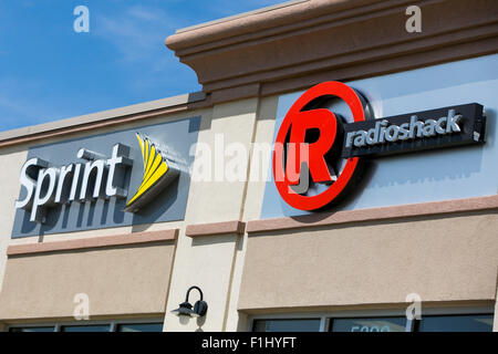 A logo sign outside of a joint Sprint and Radioshack store in Kansas City, Kansas on August 23, 2015. Stock Photo