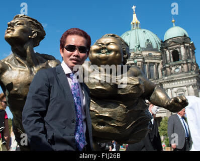 Berlin, Germany. 2nd Sep, 2015. Chinese artist Xu Hongfei poses amidst his open air sculpture's exhibition 'Chubby women' in Berlin, Germany, 2 September 2015. Hongfei's exhibition was opened the same day in the afternoon. Many of his works will be displayed around the city (especially Potsdamer Platz) until 13 September 2015. PHOTO: BERND VON JURTCZENKA/dpa/Alamy Live News Stock Photo