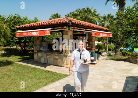 A waitress carries a tray of drinks at an ice-cream cafe Stock Photo