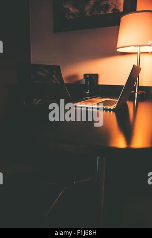 Hotel Computer Work Station at Night. Working When Travel Stock Photo