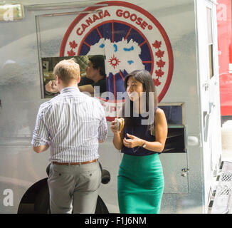 Ice cream lovers line up for a cool treat from the Coolhaus ice cream truck courtesy of the Canada Goose outdoor apparel company on Tuesday, September 1, 2015. The Canada Goose promotion was to promote the launch of their e-commerce site in the U.S. market. Their thousand dollar super-warm parkas were extremely popular and ubiquitous last winter and now you can order them online in the U.S.. (© Richard B. Levine) Stock Photo