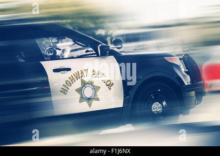 California Highway Police in Motion. SUV Police Cruiser on a Highway. Stock Photo