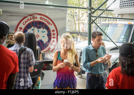 Ice cream lovers line up for a cool treat from the Coolhaus ice cream truck courtesy of the Canada Goose outdoor apparel company on Tuesday, September 1, 2015. The Canada Goose promotion was to promote the launch of their e-commerce site in the U.S. market. Their thousand dollar super-warm parkas were extremely popular and ubiquitous last winter and now you can order them online in the U.S.. (© Richard B. Levine) Stock Photo