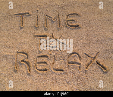 In the picture the words on the sand 'Time to relax' Stock Photo