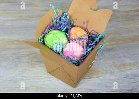 Colorful French macaroons in generic brown take out container. Stock Photo