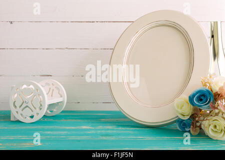 White vintage photo frame on table with decoration background. Stock Photo