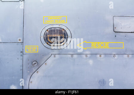 British GR3 Jaguar Fighter. Close up of rescue arrow sign by cockpit with other yellow signs, 'emergency release explosive canopy'. Stock Photo