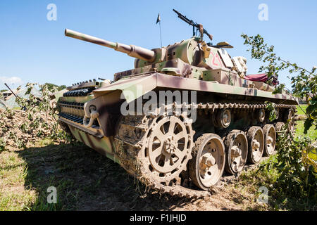 Living history re-enactment of world war two. A German Panzer IV medium tank . Close up with tank filling frame. Parked on grass, with blue sky. Stock Photo