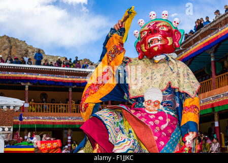 Monks with big wooden masks and colorful costumes are performing ritual dances at Hemis Festival in the courtyard of the Stock Photo