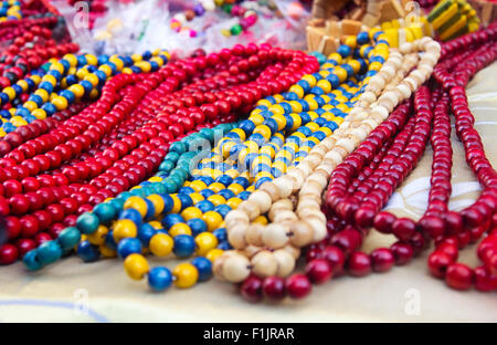 Ethnic wooden multicolored necklaces at market, traditional decorations Stock Photo