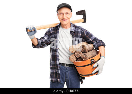 Senior man carrying an ax over his shoulder and holding basket full of logs isolated on white background Stock Photo