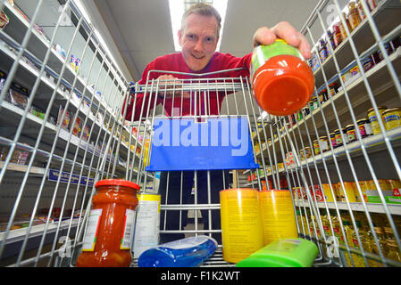 man shopping using trolley in supermarket Stock Photo