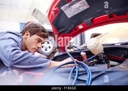 Mechanic working on car engine Stock Photo