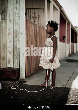 Girl playing with a piece of rope, Sophiatown, Cape Town, Western Cape Stock Photo