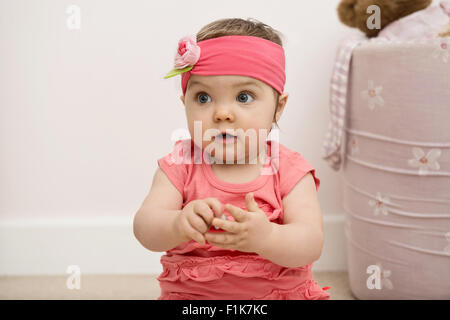 Smiling girl sitting on floor Stock Photo - Alamy