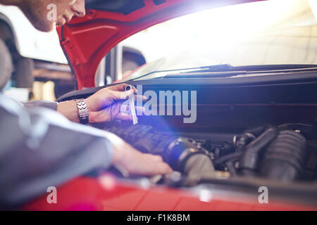 Mechanic working on car engine Stock Photo - Alamy