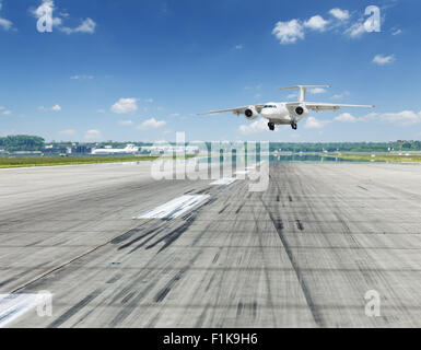 Airplane landing on runaway in the airport. Stock Photo