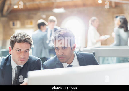 Serious businessmen using computer in office Stock Photo