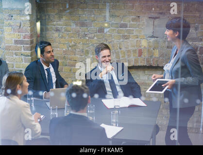 Businesswoman leading meeting in conference room Stock Photo